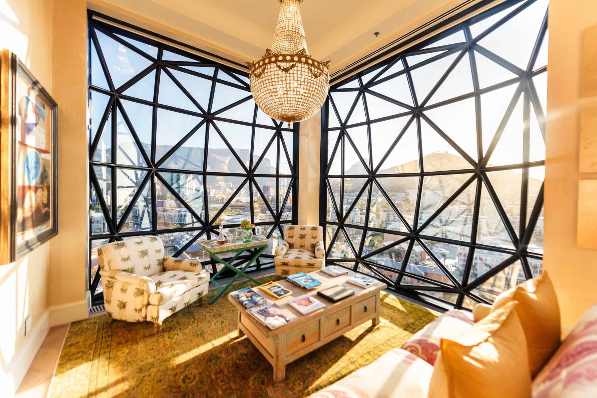 A sitting room at The Silo Hotel, its geometric glass windows looking over the V&A Waterfront